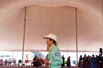 Chris Churley and his dance partner Flossie Silversmith participate in a traditional step dance during the Central Navajo Fair in Chinle Saturday. © 2011 Gallup Independent / Cable Hoover 